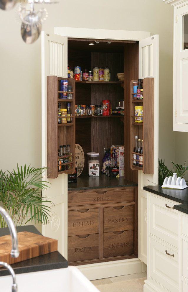 This is an example of a traditional kitchen pantry in Edinburgh with raised-panel cabinets and white cabinets.