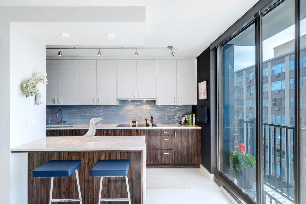 Large contemporary galley eat-in kitchen in Dallas with flat-panel cabinets, dark wood cabinets, marble benchtops, blue splashback, matchstick tile splashback, a peninsula, an undermount sink, stainless steel appliances, porcelain floors and white floor.