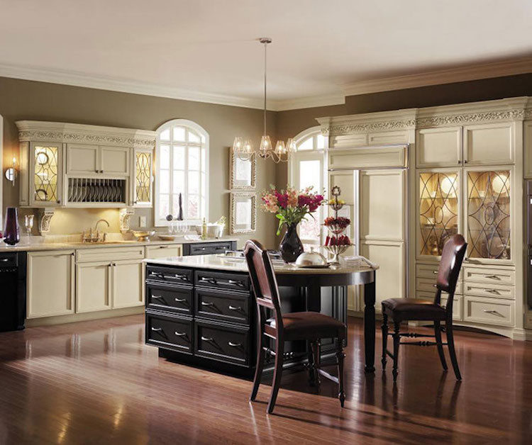 Mid-sized transitional l-shaped dark wood floor and brown floor eat-in kitchen photo in Orange County with an undermount sink, raised-panel cabinets, white cabinets, granite countertops, beige backsplash, ceramic backsplash, stainless steel appliances and an island