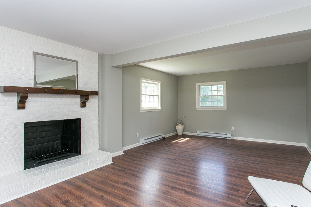 Inspiration for a mid-sized traditional formal open concept living room in Wilmington with grey walls, medium hardwood floors, a standard fireplace and a brick fireplace surround.