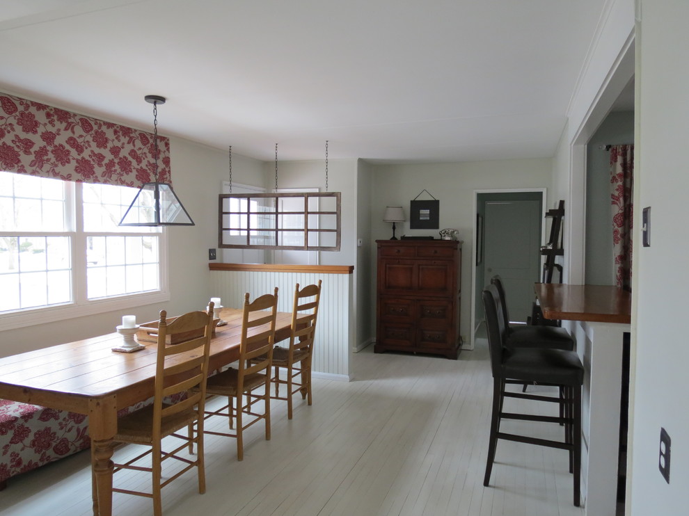 Design ideas for a mid-sized transitional dining room in Boston with grey walls and painted wood floors.