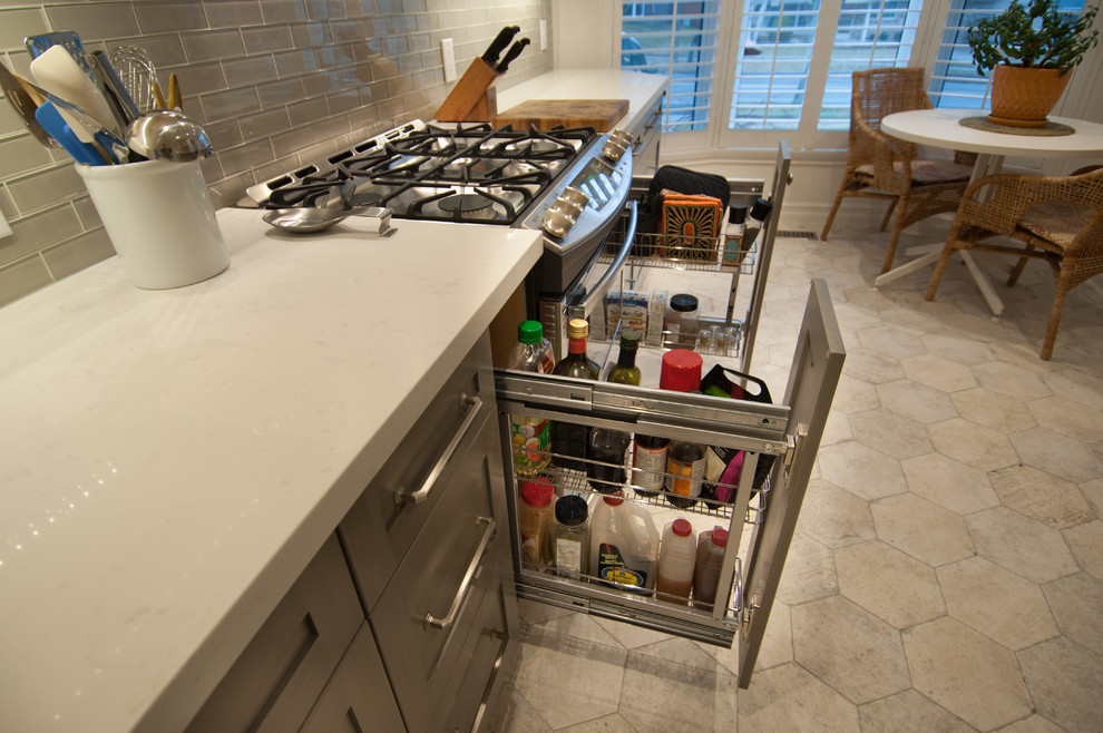 Example of a mid-sized transitional galley ceramic tile enclosed kitchen design in Toronto with shaker cabinets, white cabinets, quartzite countertops, gray backsplash, glass tile backsplash, stainless steel appliances and no island