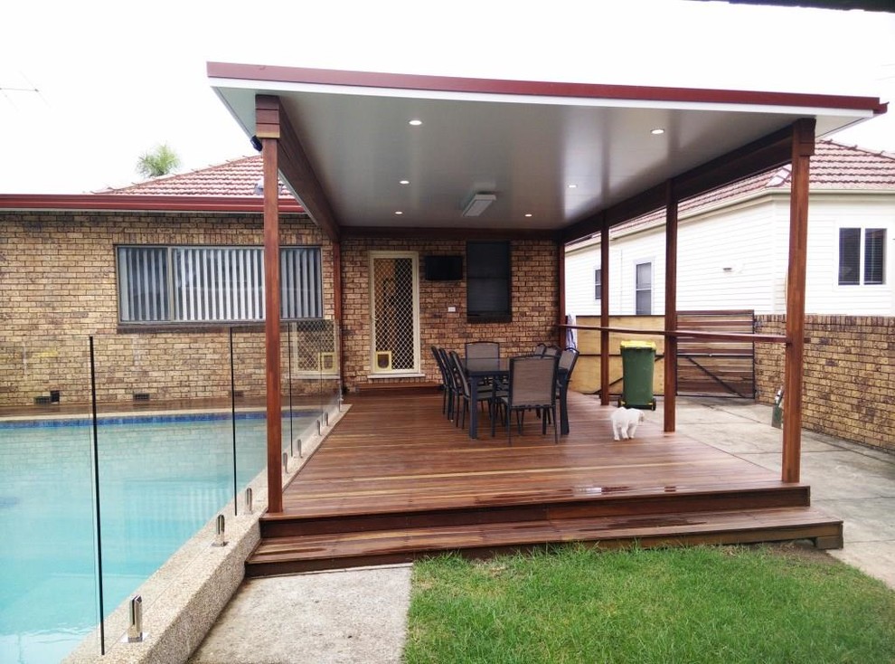 Inspiration for a mid-sized modern backyard deck in Sydney with a pergola.