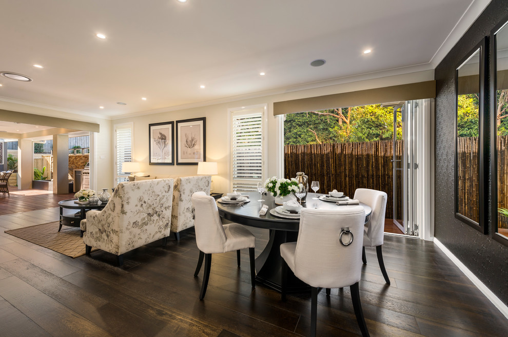 Mid-sized tropical open plan dining in Brisbane with white walls and dark hardwood floors.