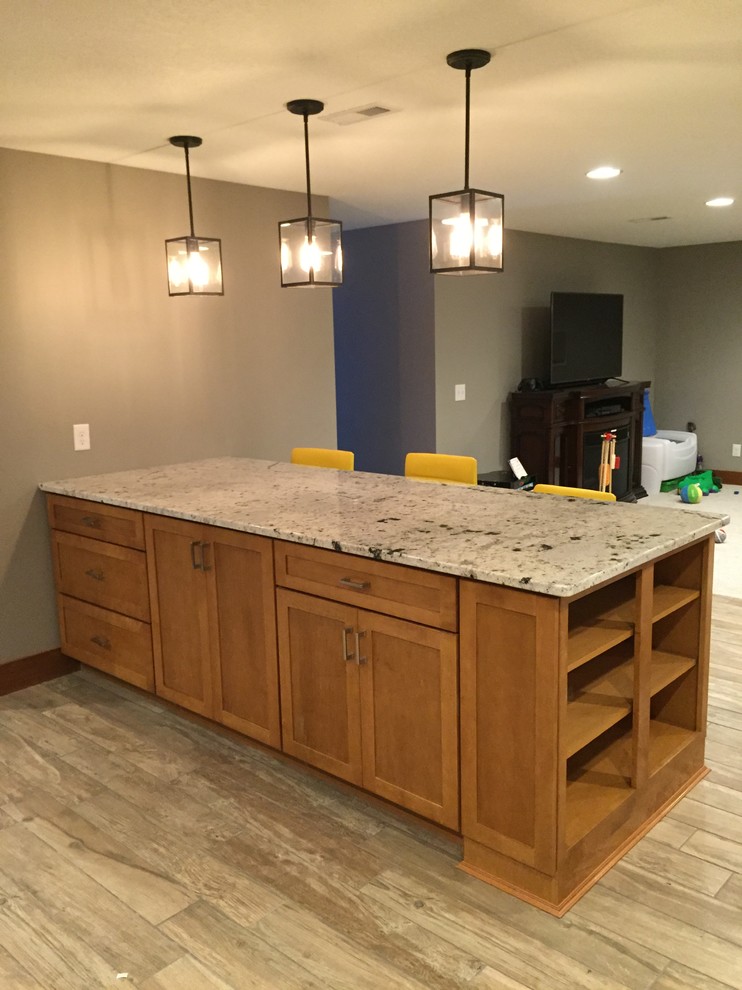 Mid-sized traditional u-shaped open plan kitchen in Other with an undermount sink, shaker cabinets, medium wood cabinets, granite benchtops, black appliances and with island.