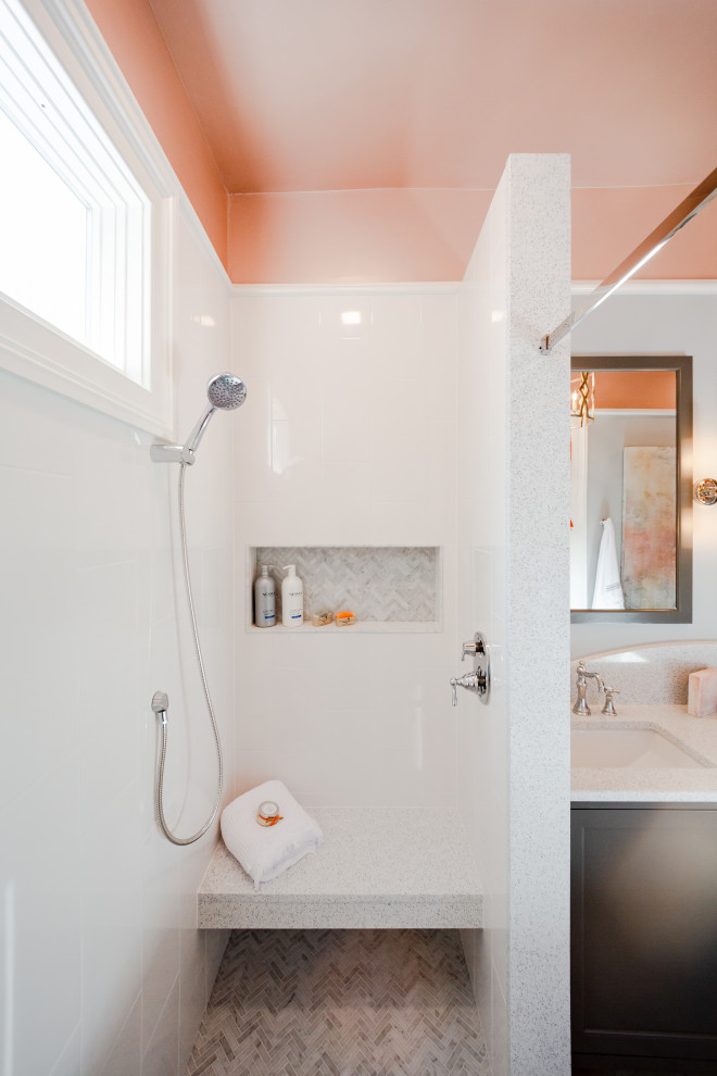 This is an example of a mid-sized transitional master bathroom in Charleston with shaker cabinets, grey cabinets, a freestanding tub, an alcove shower, a two-piece toilet, white tile, porcelain tile, an undermount sink, grey floor, white benchtops, a shower seat, a double vanity, a built-in vanity, marble floors, engineered quartz benchtops and a sliding shower screen.