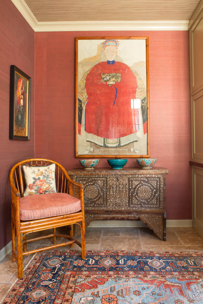 Mid-sized eclectic study room in Los Angeles with red walls, travertine floors, no fireplace and a built-in desk.
