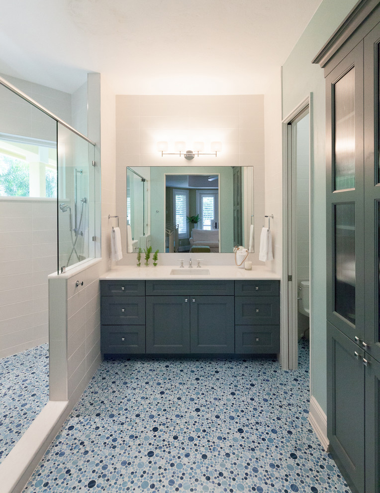 Design ideas for a mid-sized contemporary kids bathroom in Tampa with an undermount sink, shaker cabinets, blue cabinets, engineered quartz benchtops, an open shower, blue tile, porcelain tile, white walls and mosaic tile floors.