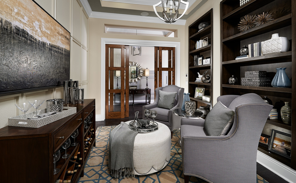 Inspiration for a mid-sized transitional study room in Orlando with beige walls, dark hardwood floors and a built-in desk.
