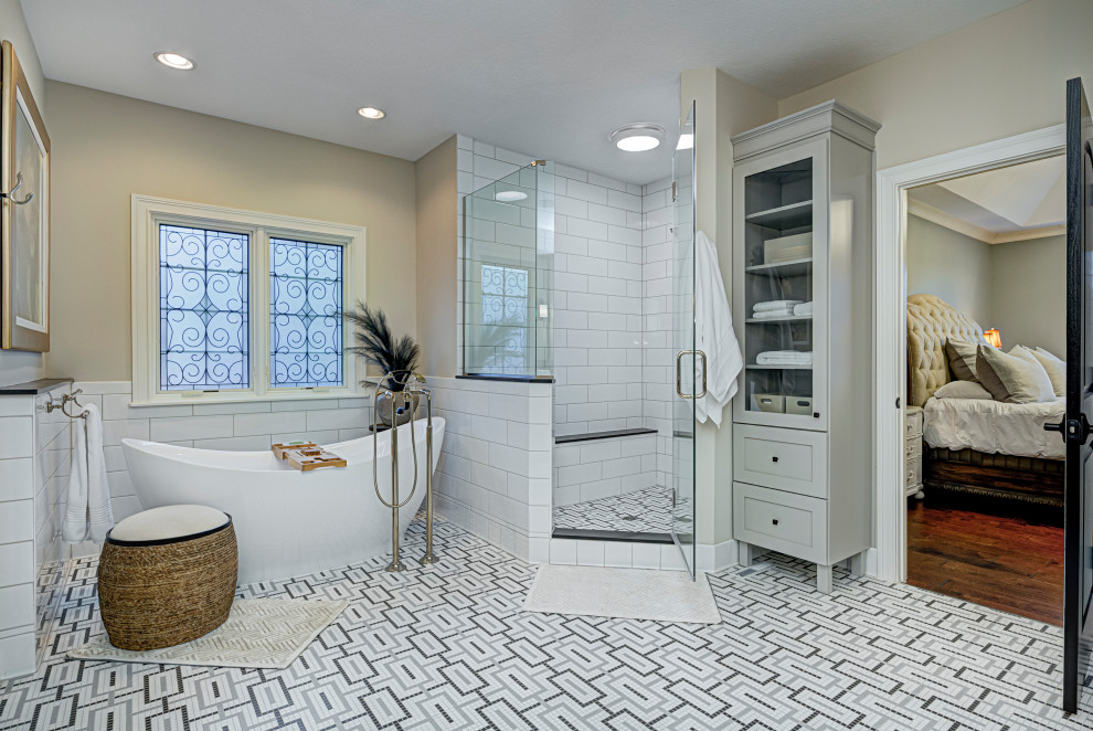 Inspiration for a mid-sized contemporary master bathroom in Indianapolis with a corner tub, a shower/bathtub combo, white tile, subway tile, beige walls, porcelain floors, multi-coloured floor, a hinged shower door and a shower seat.
