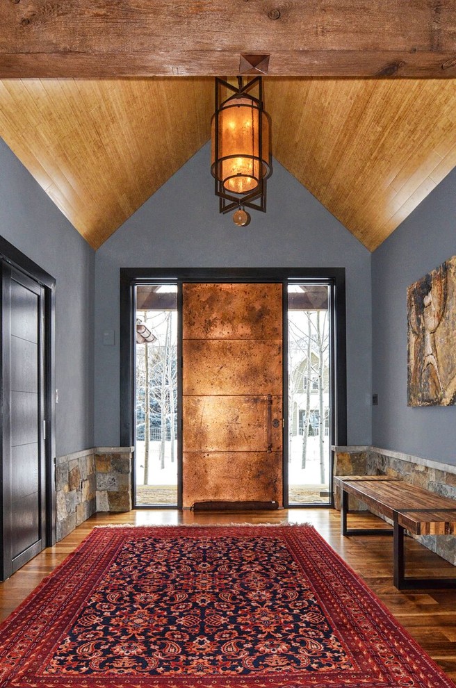Large industrial foyer in Denver with grey walls, medium hardwood floors, a single front door and a metal front door.