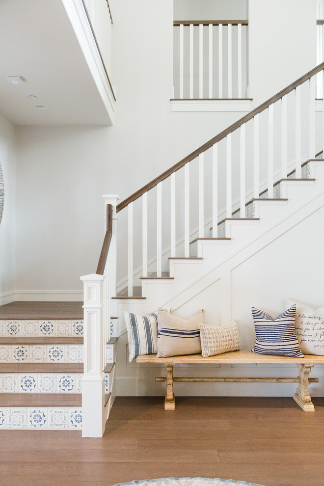 Inspiration for a beach style wood l-shaped staircase in San Diego with tile risers and wood railing.
