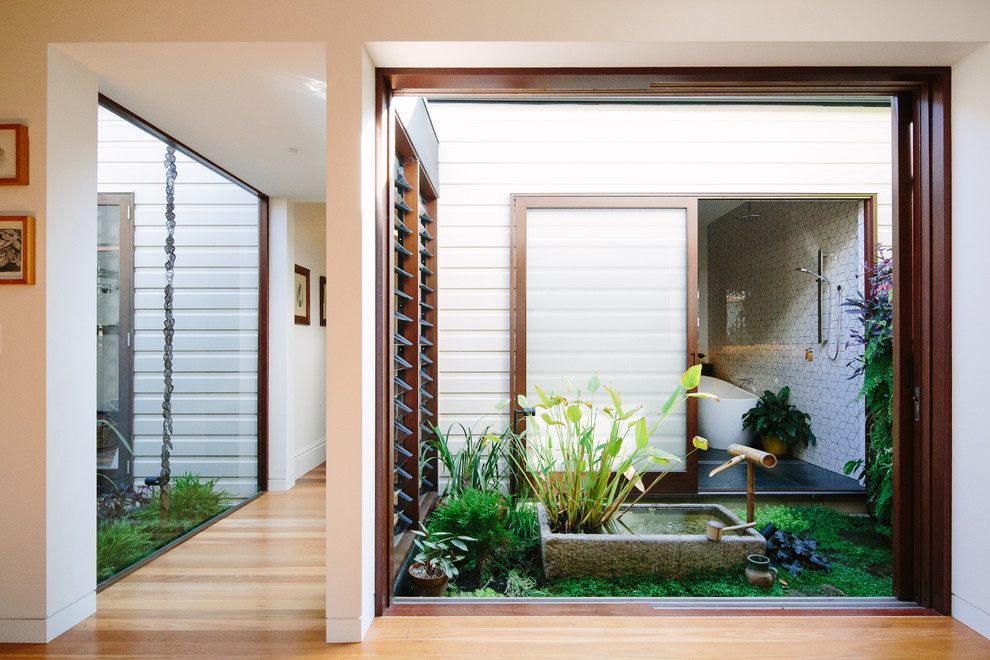 Inspiration for a small contemporary courtyard partial sun formal garden in Sydney with a water feature.