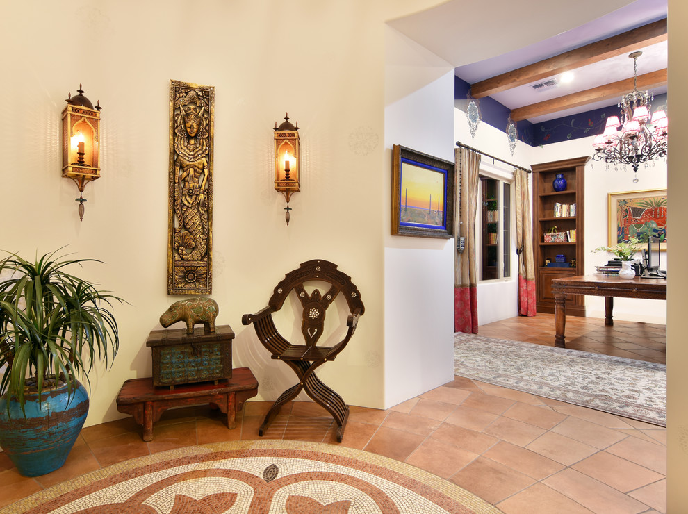 Inspiration for a mid-sized mediterranean foyer in Phoenix with beige walls, terra-cotta floors and orange floor.