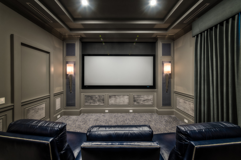 Photo of a mid-sized transitional enclosed home theatre in Tampa with carpet, grey walls, a projector screen and grey floor.