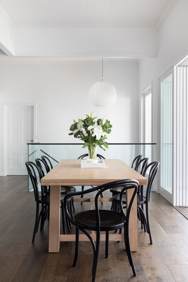 This is an example of a large contemporary open plan dining in Brisbane with white walls, dark hardwood floors, brown floor, planked wall panelling and timber.