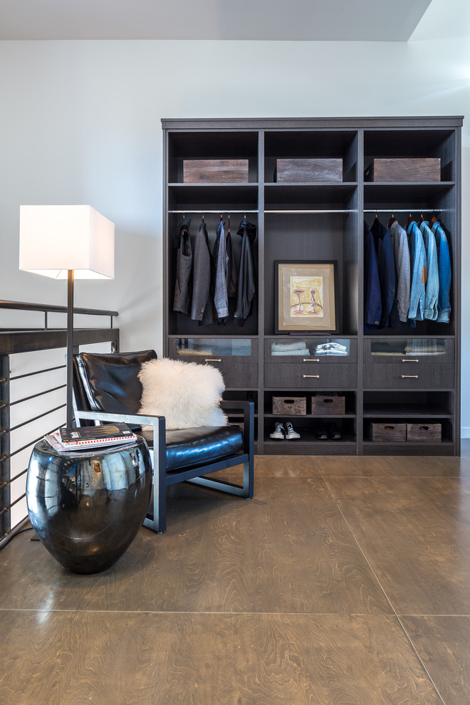 Photo of a contemporary men's storage and wardrobe in Los Angeles with open cabinets and dark wood cabinets.