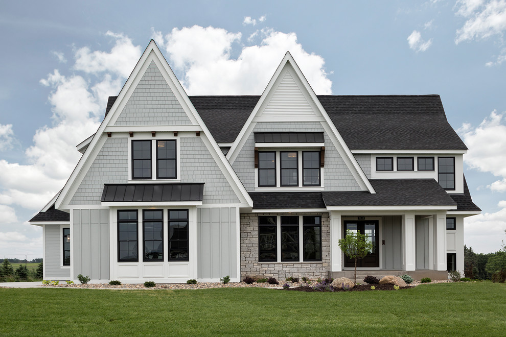 Inspiration for a large transitional two-storey grey house exterior in Minneapolis with concrete fiberboard siding, a gable roof and a mixed roof.