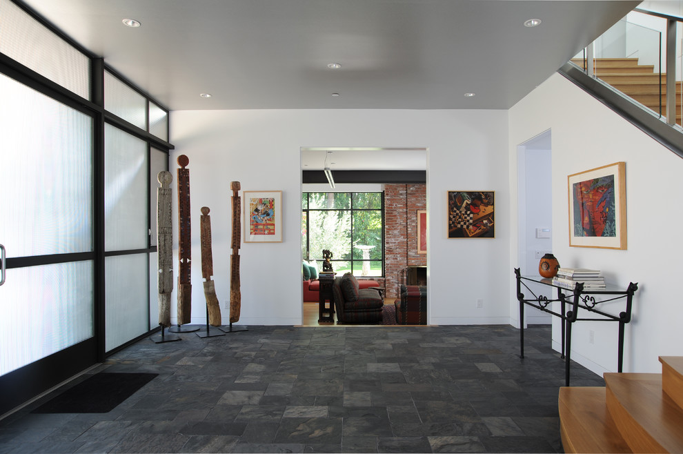 This is an example of a contemporary entryway in Boston with slate floors and white walls.