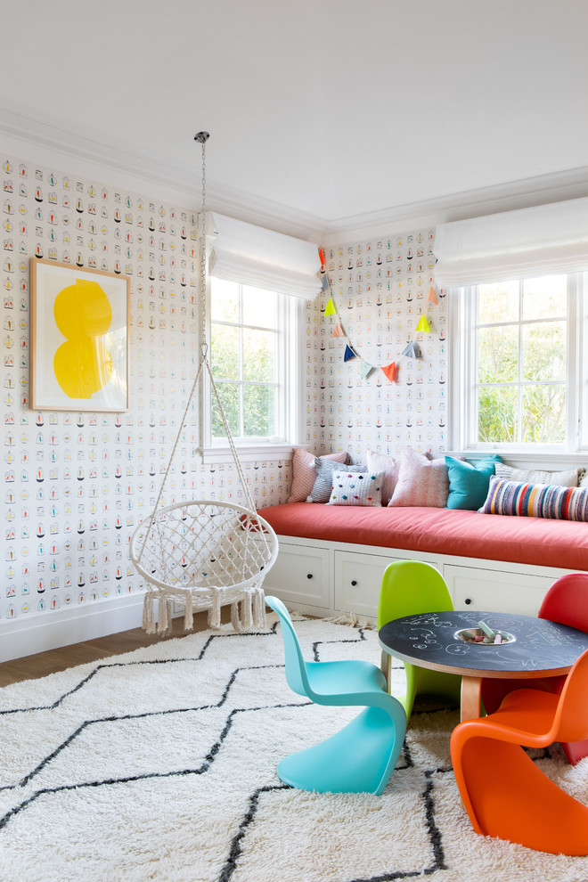 Design ideas for a large modern gender-neutral kids' playroom for kids 4-10 years old in New York with light hardwood floors and beige floor.