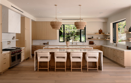 Modern farmhouse kitchen with light wood RTA cabinets, marble waterfall island, open shelves, and woven pendant lights