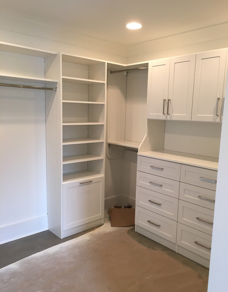 This is an example of a large traditional gender-neutral walk-in wardrobe in Chicago with shaker cabinets and white cabinets.
