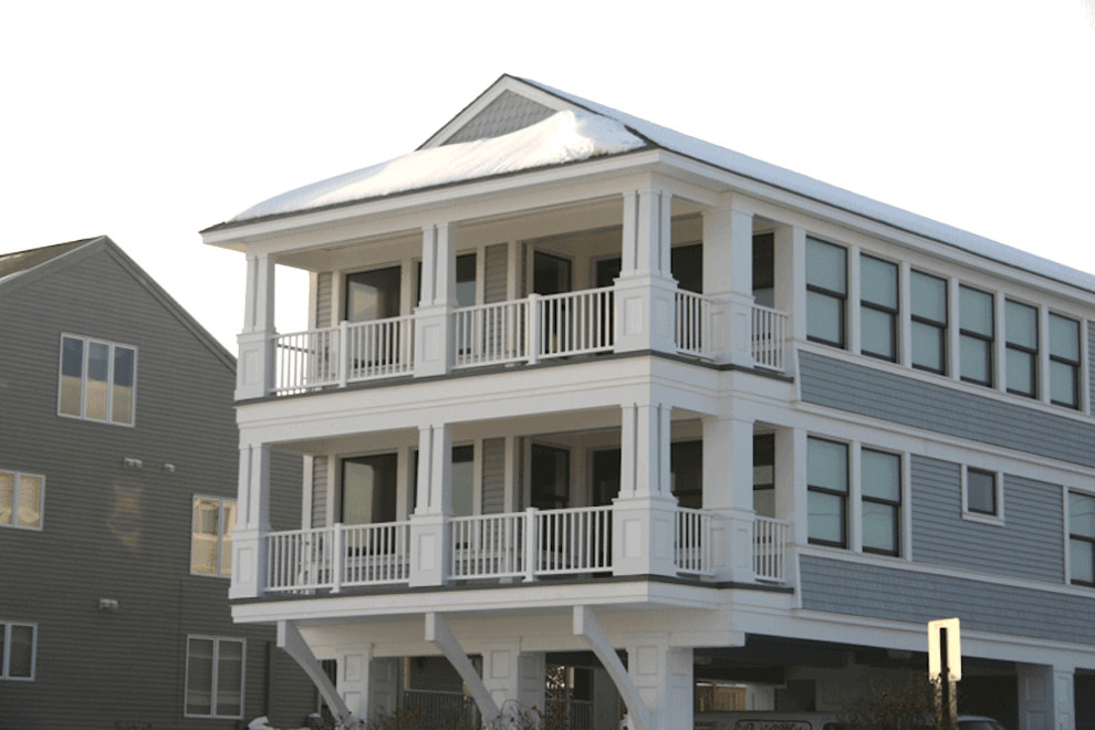 Design ideas for a large beach style three-storey white exterior in Portland Maine.