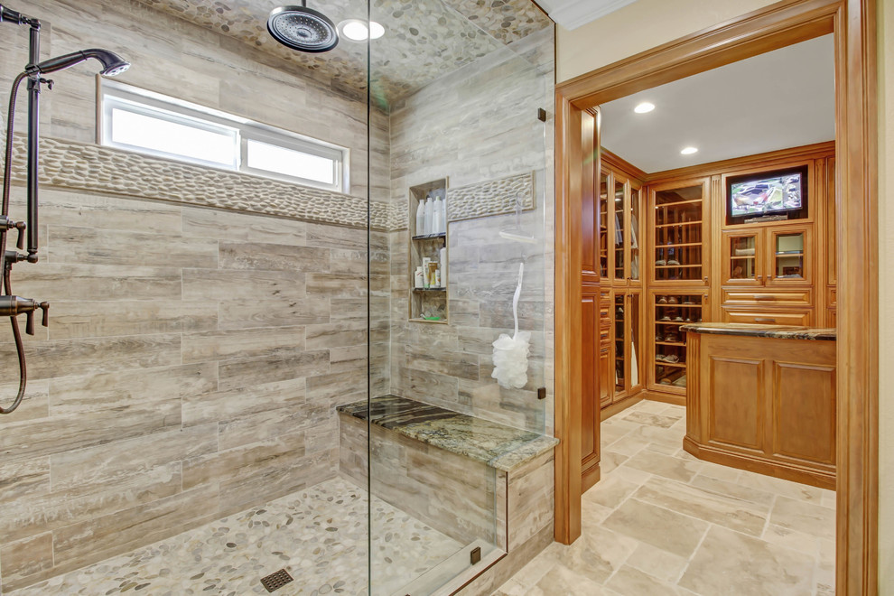 Design ideas for a large traditional master bathroom in Los Angeles with raised-panel cabinets, medium wood cabinets, a double shower, multi-coloured tile, pebble tile, a vessel sink, granite benchtops, a hinged shower door, beige walls, travertine floors and beige floor.
