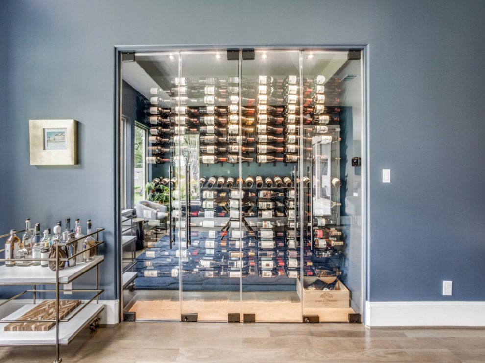 This is an example of a midcentury wine cellar in Houston.