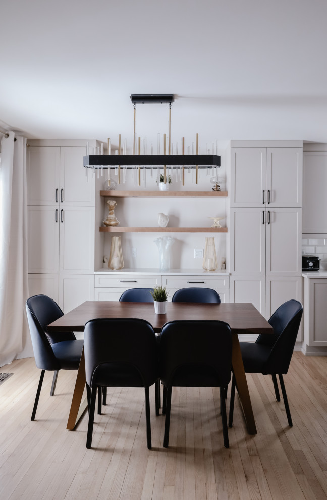 Eat-in kitchen - mid-sized transitional l-shaped light wood floor and brown floor eat-in kitchen idea with an undermount sink, shaker cabinets, beige cabinets, quartz countertops, white backsplash, subway tile backsplash, stainless steel appliances, an island and white countertops