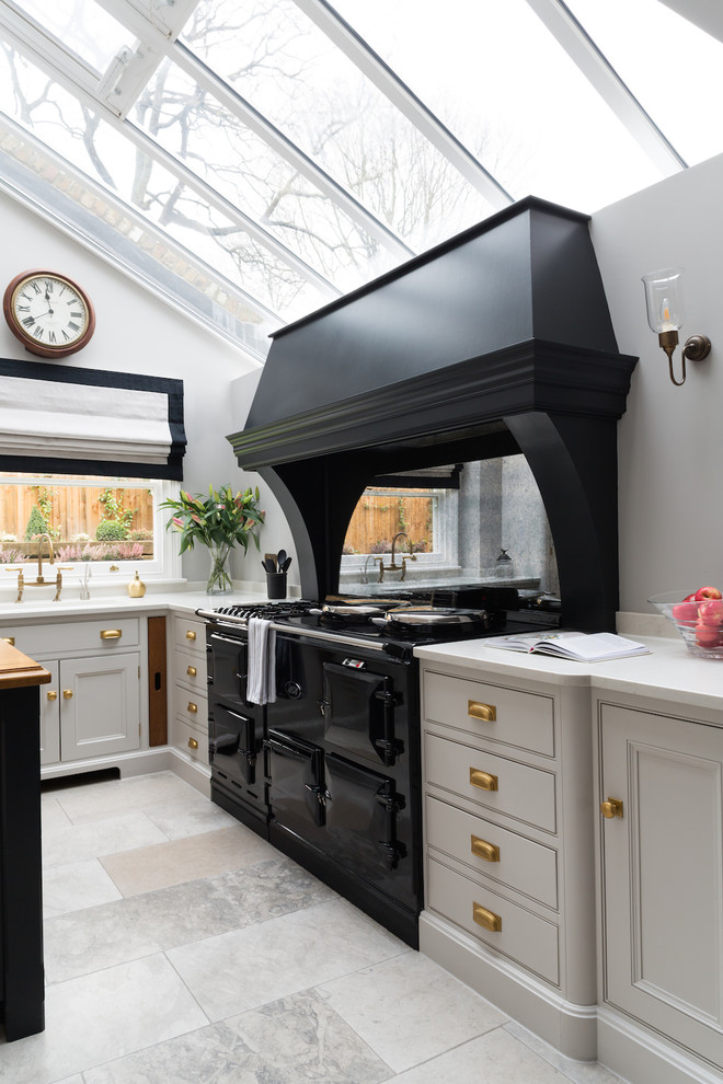 Design ideas for a mid-sized transitional u-shaped kitchen in London.
