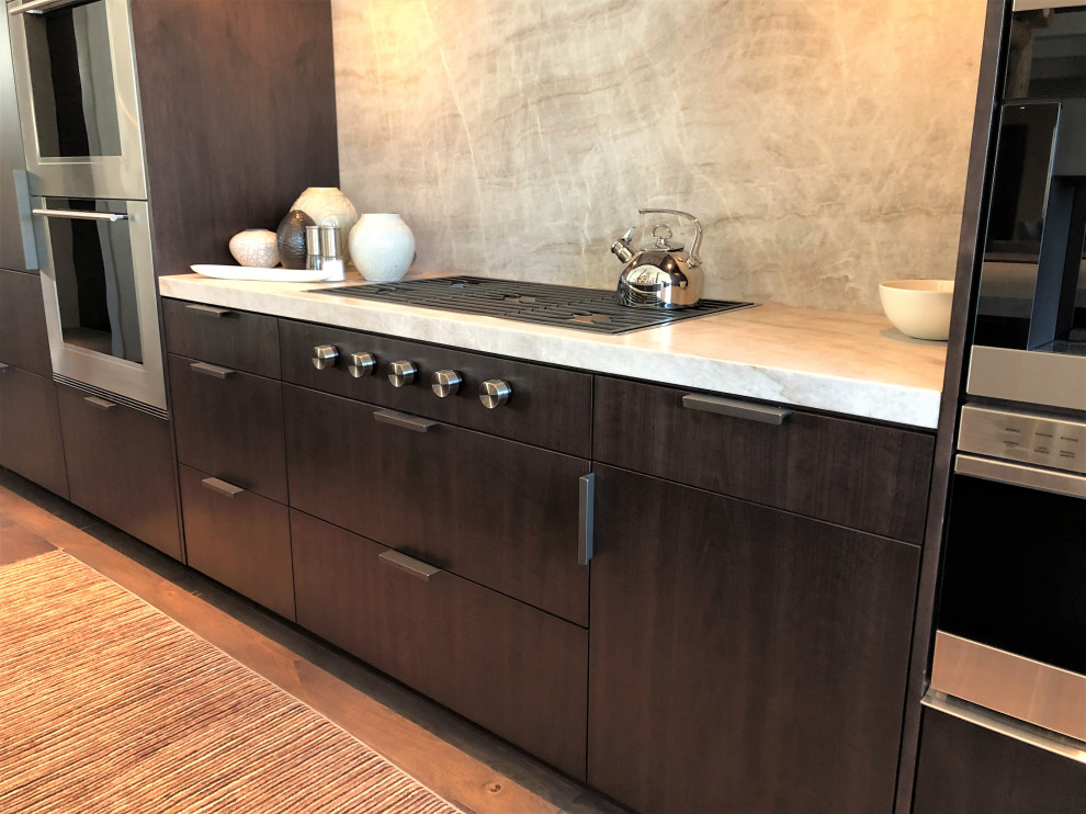 Large contemporary galley open plan kitchen in Other with an undermount sink, flat-panel cabinets, dark wood cabinets, coloured appliances, medium hardwood floors, with island, brown floor, multi-coloured benchtop and vaulted.