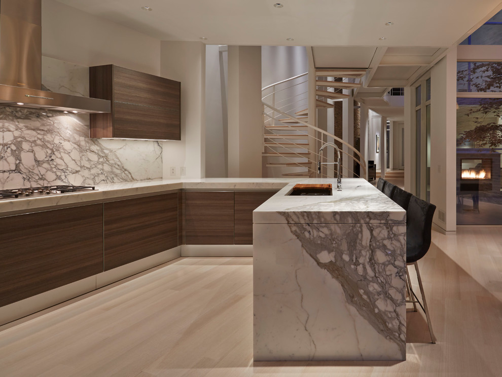 Inspiration for a contemporary u-shaped kitchen remodel in Chicago with an undermount sink, stone slab backsplash and a peninsula