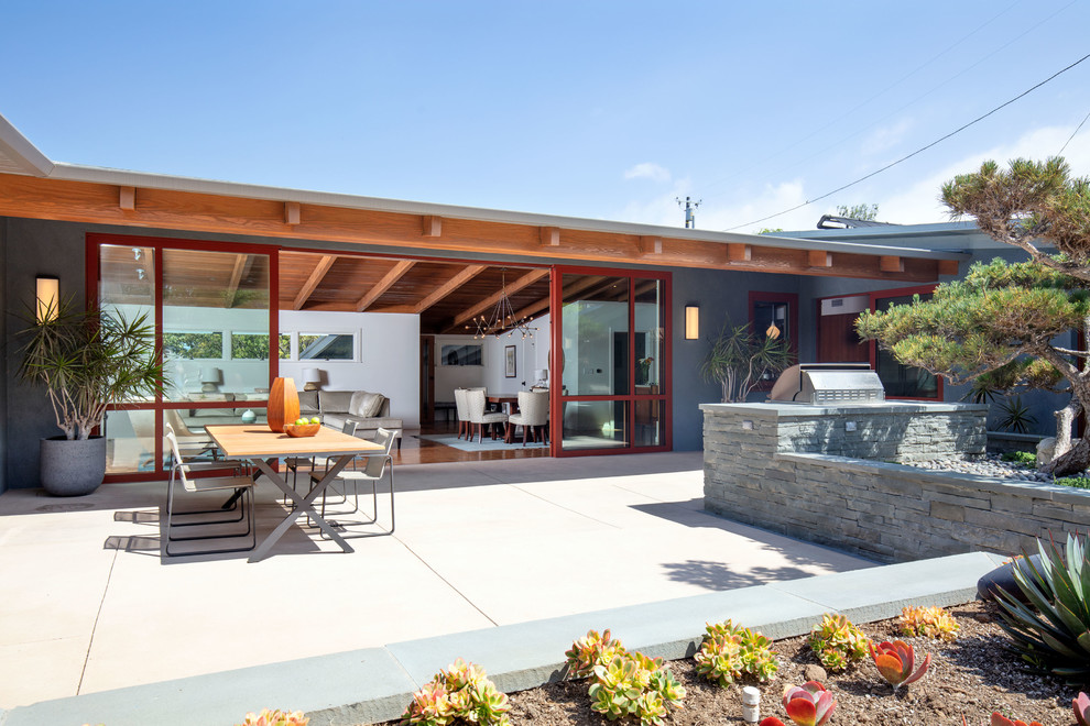 Mid-sized midcentury one-storey grey house exterior in Los Angeles with wood siding, a shed roof and a mixed roof.