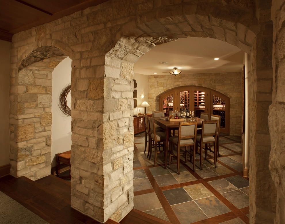 Photo of a mid-sized traditional wine cellar in Milwaukee with slate floors, storage racks and multi-coloured floor.