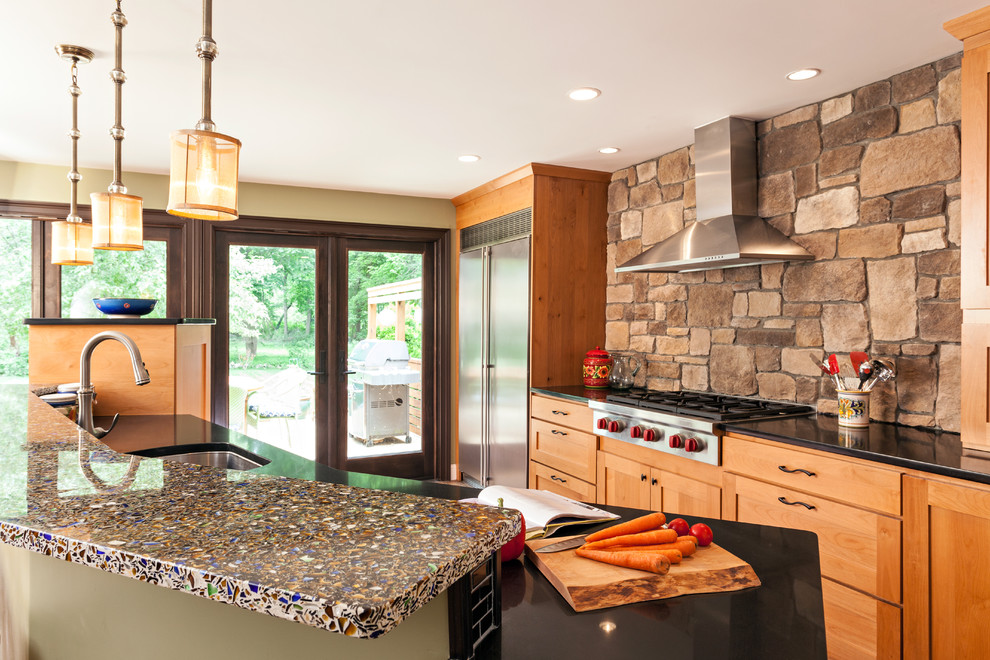 Design ideas for a mid-sized transitional u-shaped eat-in kitchen in Boston with an undermount sink, shaker cabinets, medium wood cabinets, recycled glass benchtops, brown splashback, stone tile splashback, stainless steel appliances, bamboo floors and with island.