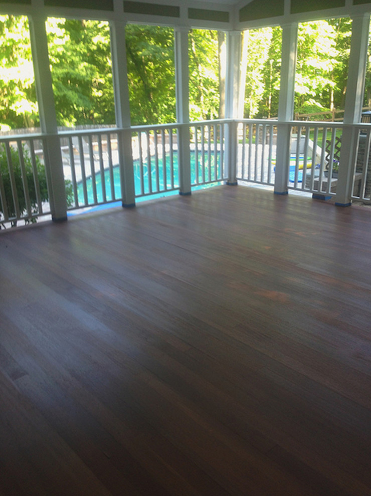 Inspiration for a mid-sized backyard deck remodel in Miami with a roof extension