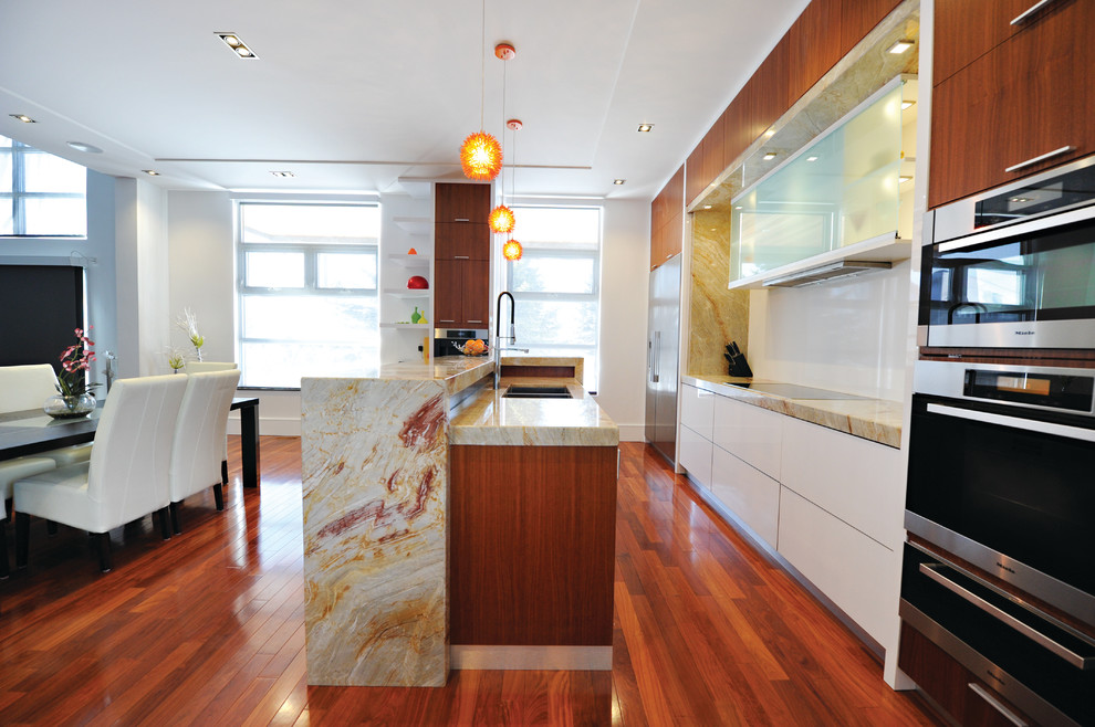 Eat-in kitchen - mid-sized transitional single-wall medium tone wood floor eat-in kitchen idea in Toronto with a double-bowl sink, flat-panel cabinets, medium tone wood cabinets, granite countertops, multicolored backsplash, stone slab backsplash, stainless steel appliances and an island