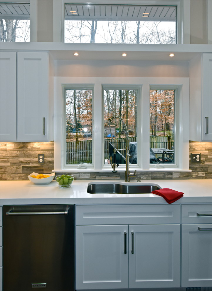 Inspiration for a contemporary kitchen in DC Metro with an undermount sink, flat-panel cabinets, white cabinets, quartz benchtops, stone tile splashback, stainless steel appliances and with island.