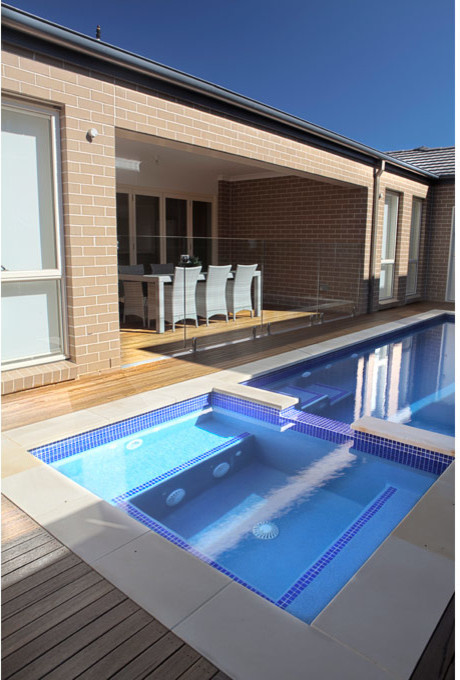Photo of a small contemporary courtyard rectangular pool in Sydney with decking.