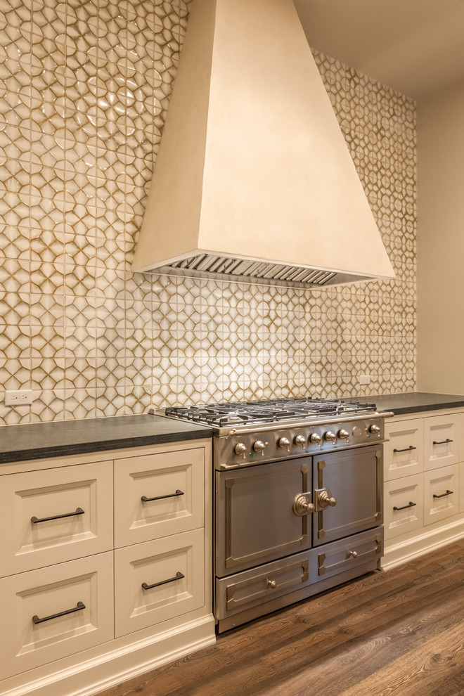 Inspiration for a large transitional l-shaped medium tone wood floor eat-in kitchen remodel in Houston with recessed-panel cabinets, marble countertops, beige backsplash, stainless steel appliances and an island