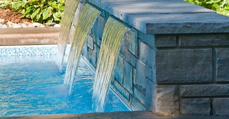 Inspiration for a large timeless backyard stone and custom-shaped natural pool fountain remodel