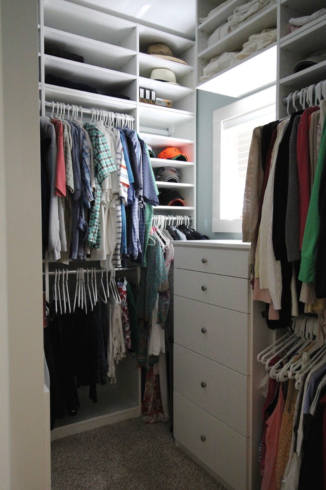 Inspiration for a small gender-neutral built-in wardrobe in Grand Rapids with white cabinets and carpet.