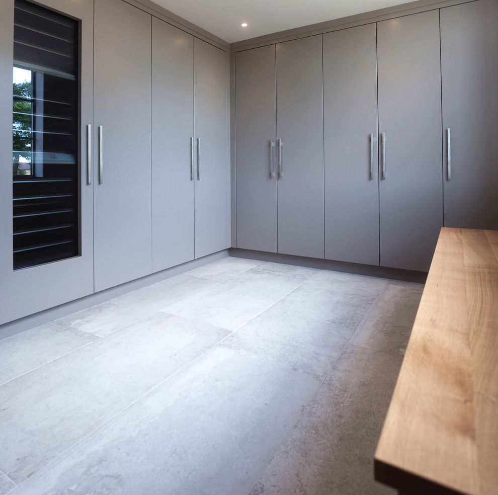 Design ideas for a large contemporary l-shaped open plan kitchen in Cheshire with flat-panel cabinets, grey cabinets, black appliances, ceramic floors and no island.