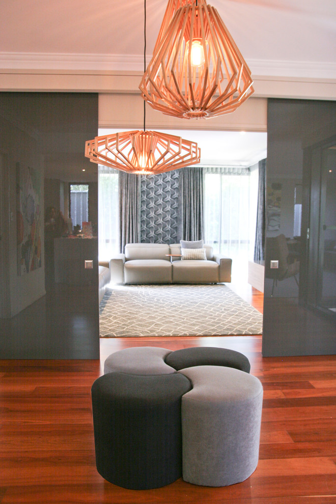 Large modern hallway in Perth with white walls, medium hardwood floors and red floor.