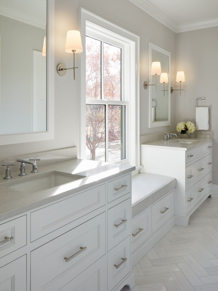 This is an example of a transitional bathroom in Other with recessed-panel cabinets, white cabinets, white tile, marble, beige walls, marble floors, an undermount sink, solid surface benchtops, white floor, beige benchtops, a double vanity and a built-in vanity.