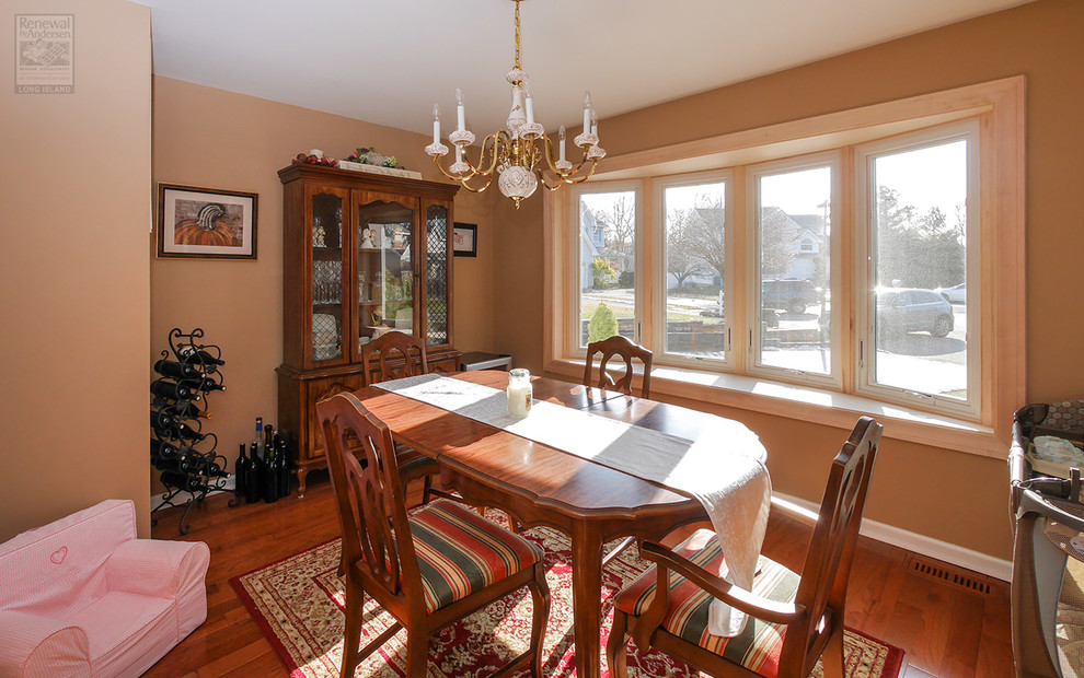 Mid-sized separate dining room in New York with beige walls, medium hardwood floors, no fireplace and multi-coloured floor.