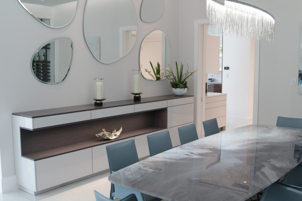 Photo of a mid-sized contemporary dining room in Miami with white walls, ceramic floors and white floor.