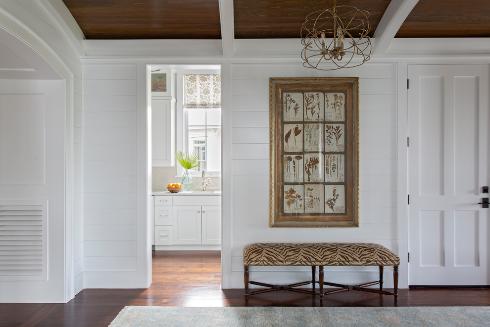 Inspiration for a beach style hallway in Charleston with white walls, dark hardwood floors and brown floor.