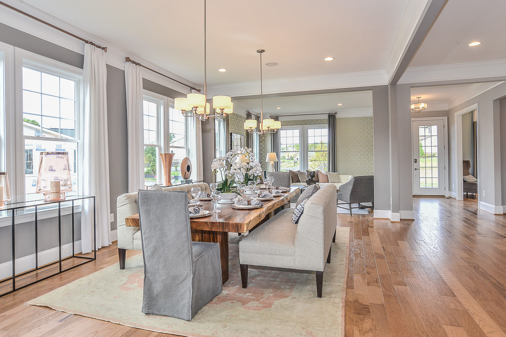 Mid-sized transitional open plan dining in DC Metro with multi-coloured walls, medium hardwood floors and a standard fireplace.